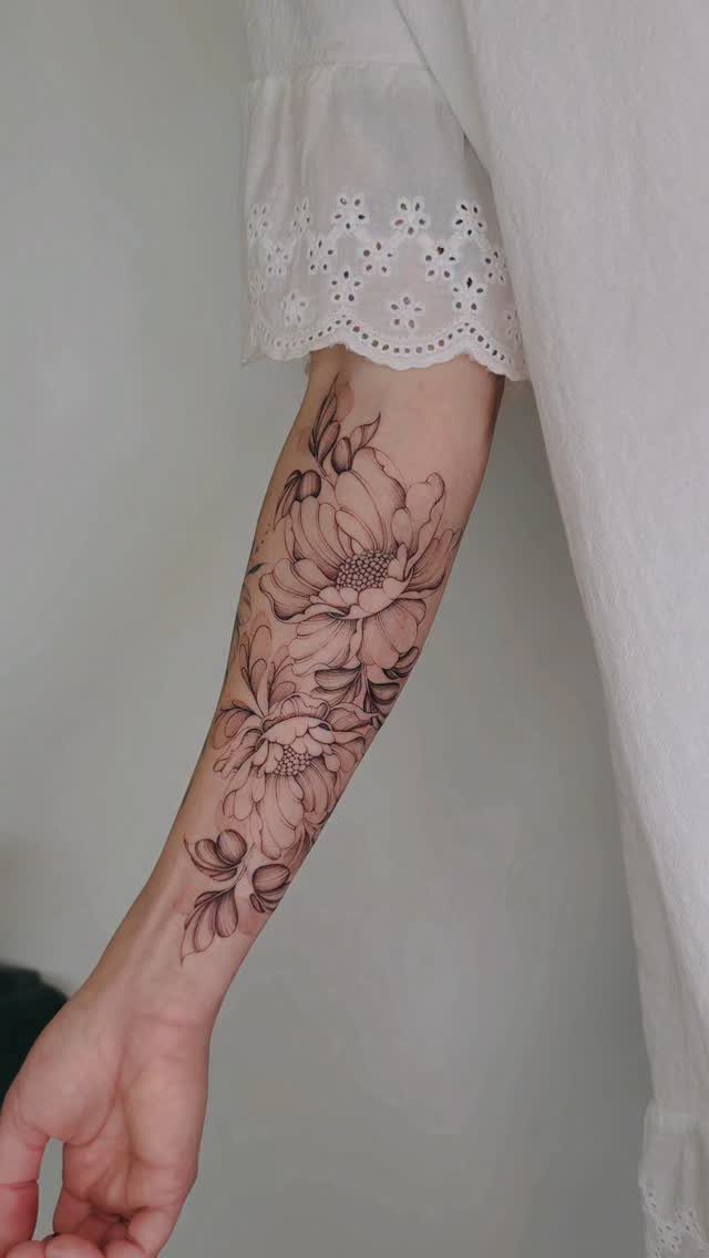 Fine Line Tattoo Placement: 11 Ideas That Actually Work 3 A large fine line peony tattoo on a person's inner forearm.
