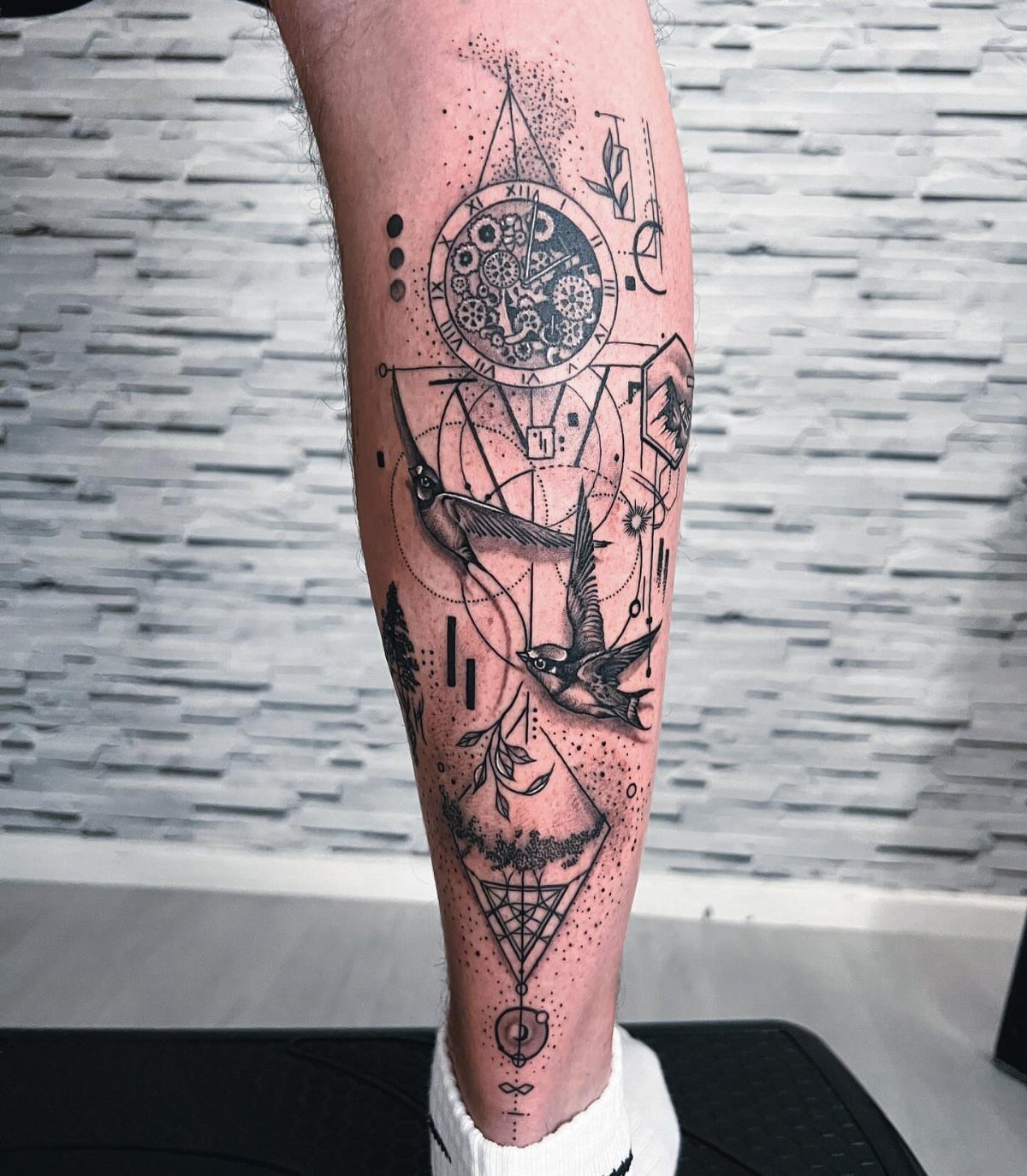 Fine Line Tattoo Placement: 11 Ideas That Actually Work 12 A detailed fine line black ink tattoo featuring a clock and birds on a person's calf.