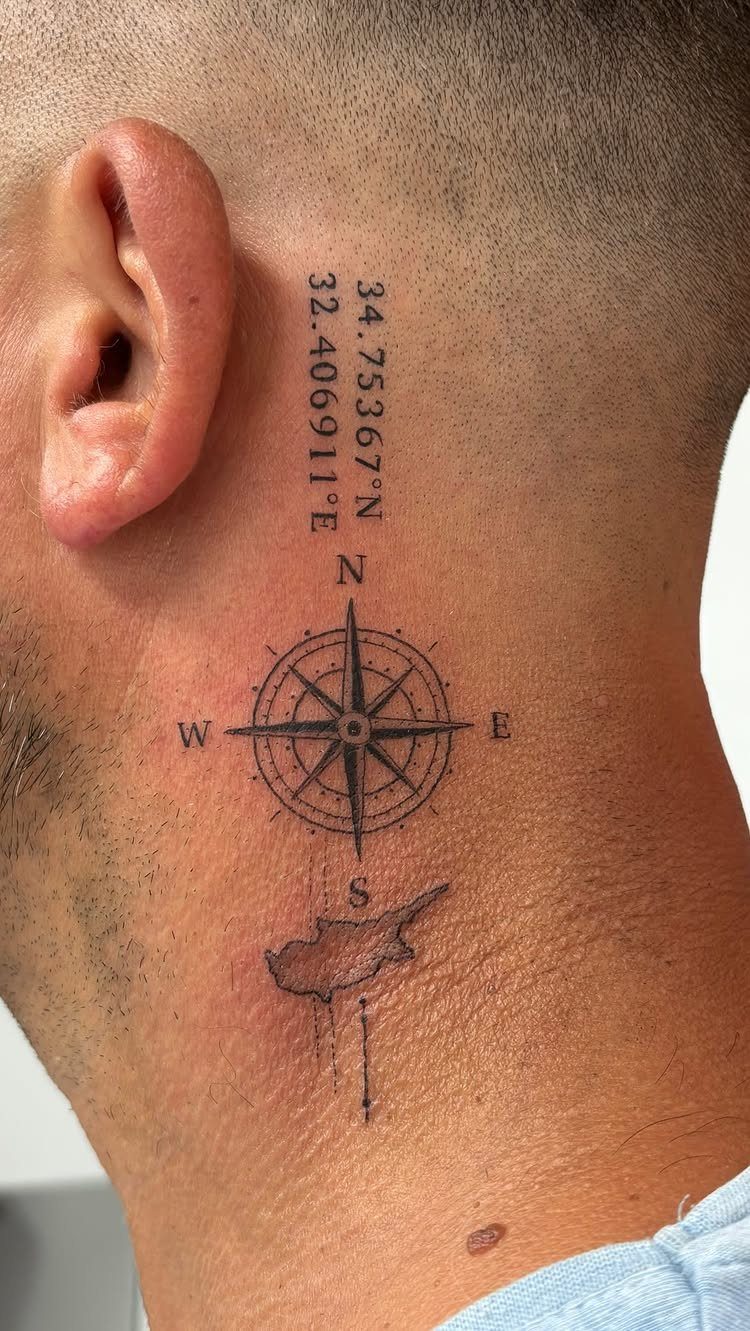 A fine-line black ink tattoo on a neck featuring a compass, coordinates, and a map.