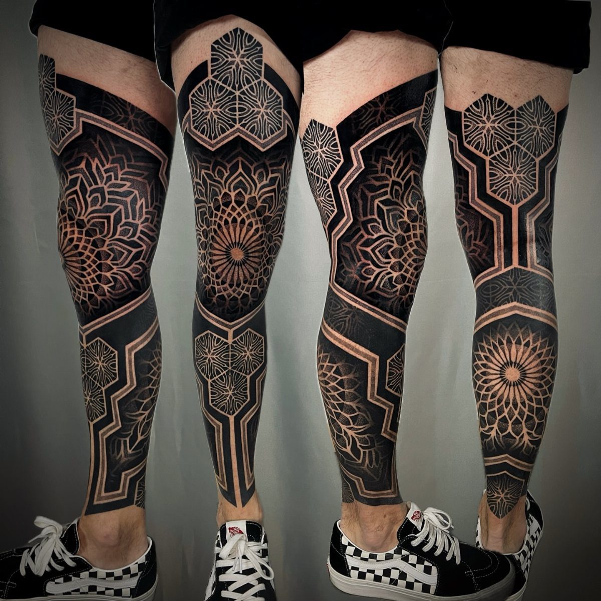 7 Full Leg Tattoo Ideas for Bold Leg Sleeves 2026 4 Two legs featuring intricate blackwork geometric sleeve tattoos with mandala and honeycomb patterns.