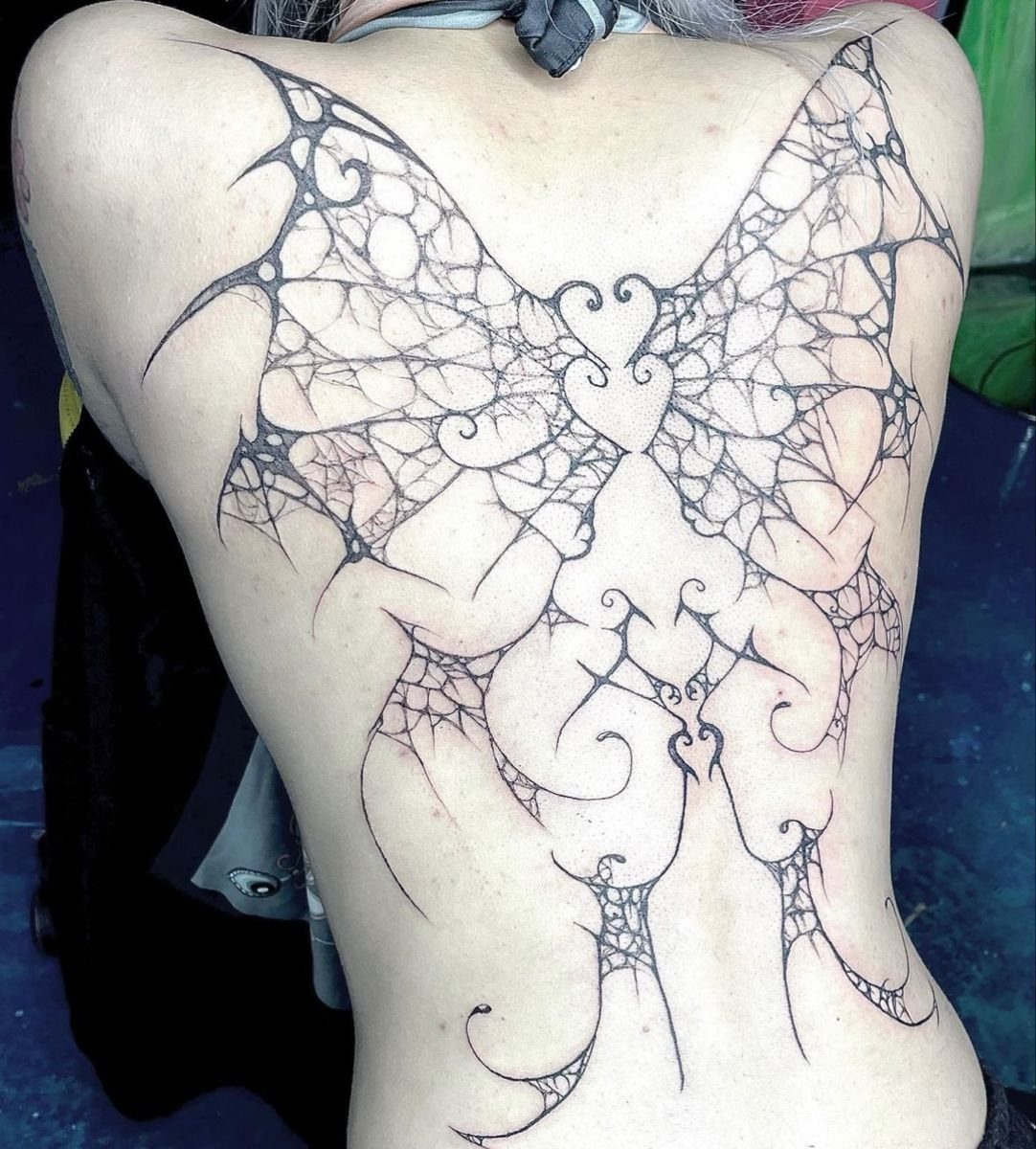 12 Back Tattoo Goth Styles for Spine, Skulls, and Full Backpieces 2 A large black ink neotribal back tattoo with intricate web patterns and heart shapes.