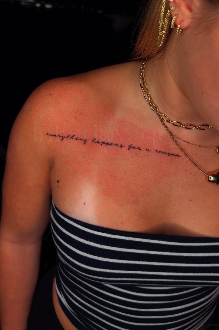 A small cursive text tattoo on a person's collarbone reading everything happens for a reason.