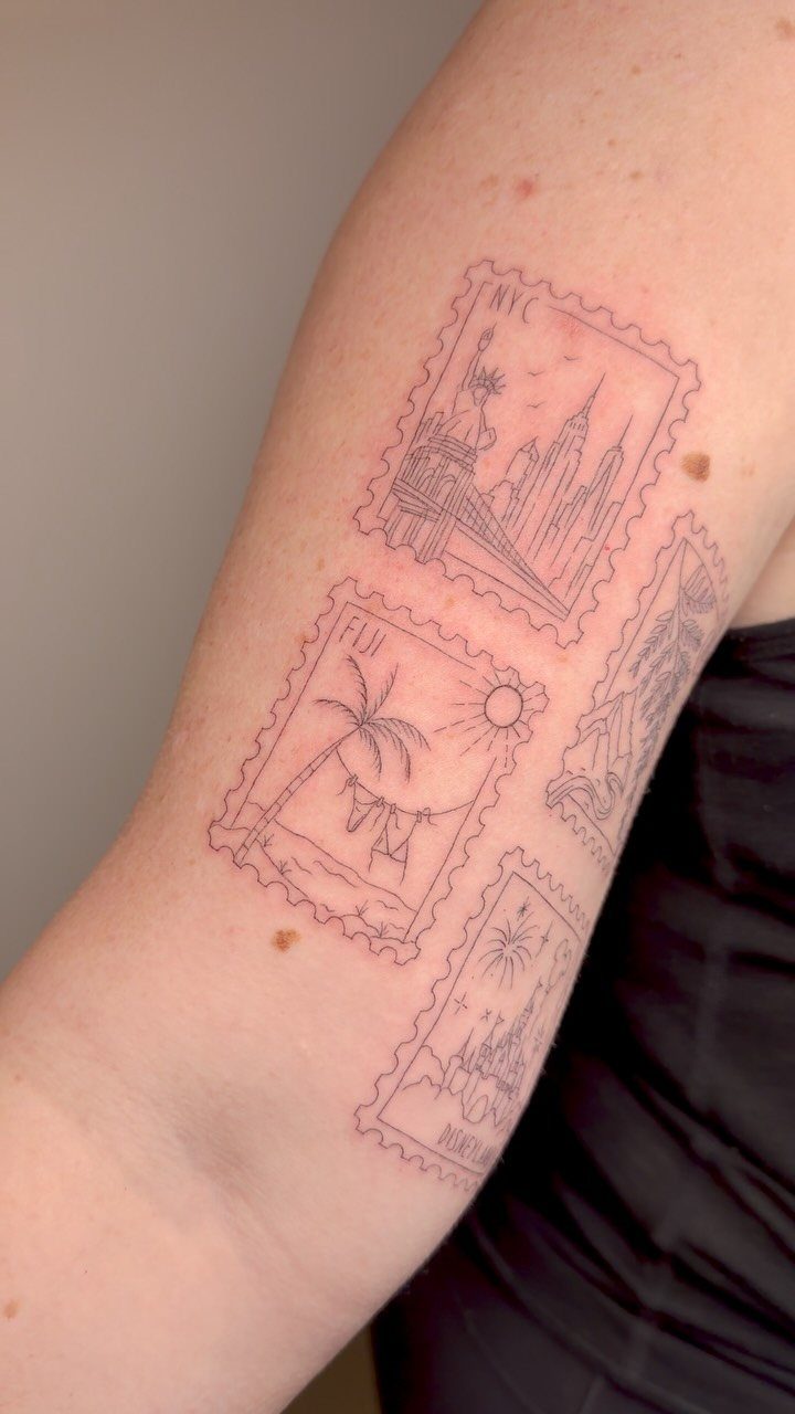 Red ink fine-line tattoos of postage stamps depicting various travel destinations on a person's arm.