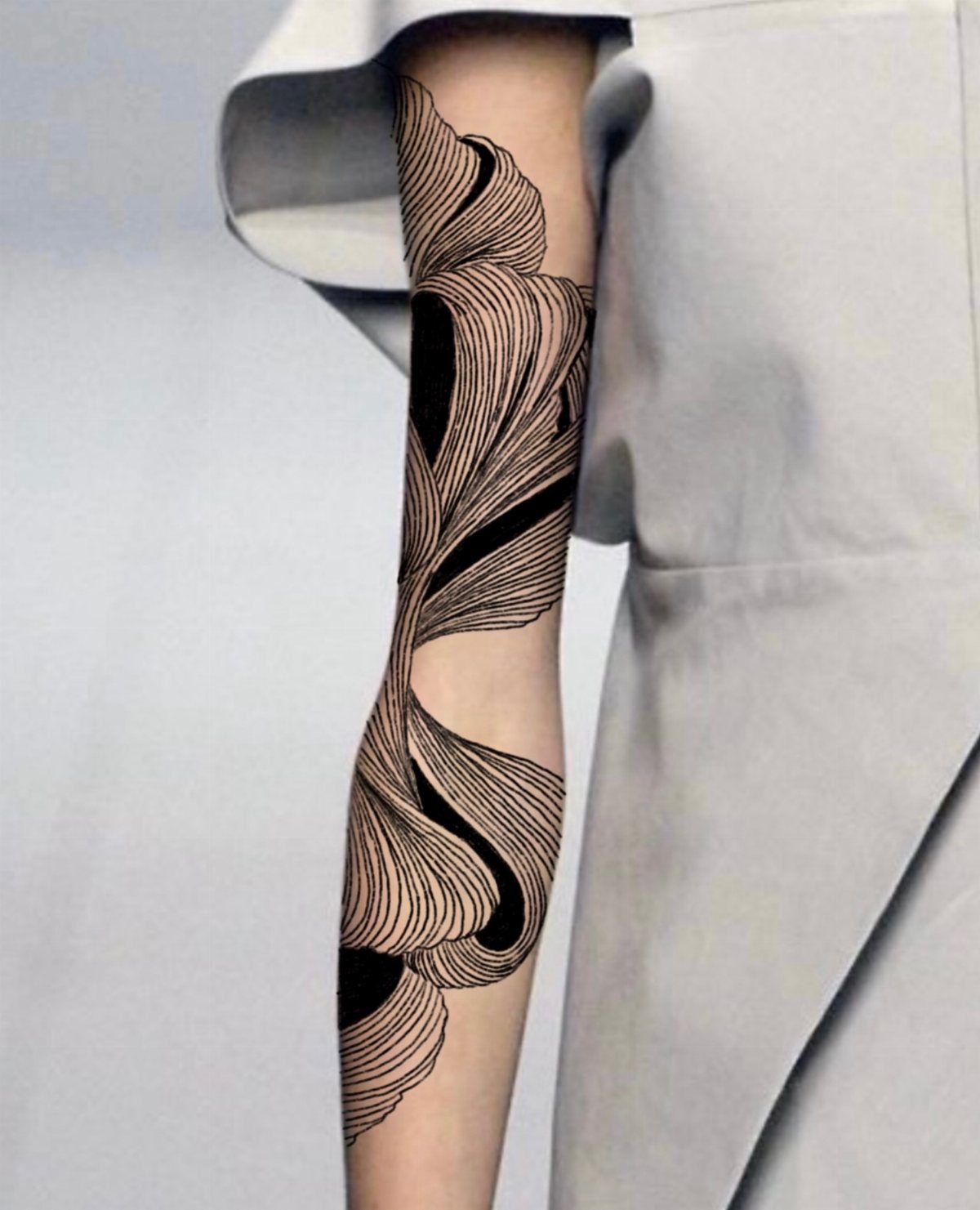 Abstract black line tattoo with flowing curves wrapping around a person's arm.