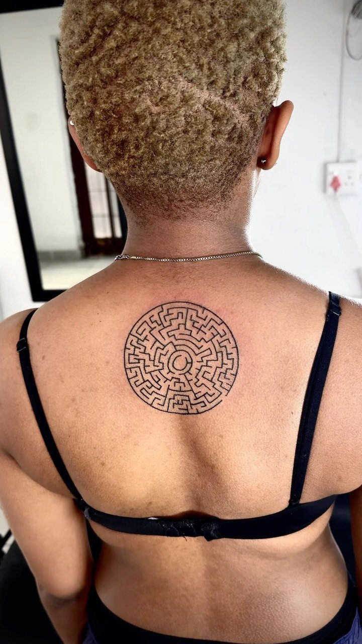 Tattoo Placement on Back: 6 Areas for Your Next Ink 3 A circular maze tattoo centered on a person's upper back.